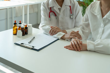 Asian female doctor in white medical uniform consult female patient in private hospital. woman therapist speak talk with woman client on consultation in clinic.の写真素材
