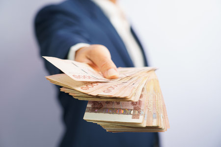 Money in thailand hold on hand business man grabbing wearing a blue suit, Filed and put and give to...