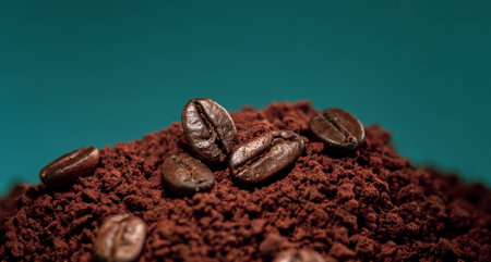 Coffee beans on a pile of ground coffee are close-ups.の写真素材
