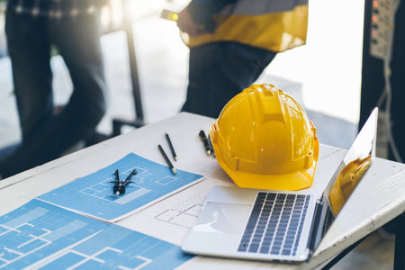 Architects and engineer concept, Architects and engineer working with blueprints construction drawing in the office.の写真素材