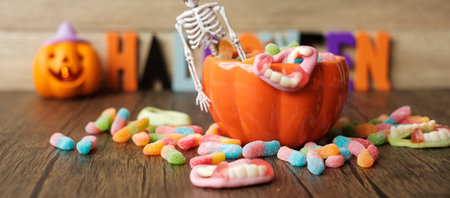 Happy Halloween day with ghost candies, pumpkin bowl, Jack O lantern and decorative (selective focus). Trick or Threat, Hello October, fall autumn, Festive, party and holiday conceptの写真素材