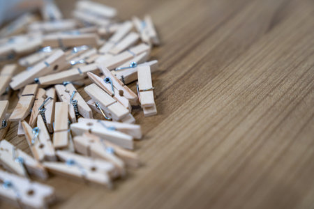 close up a lot of wooden new clips on the wood table.