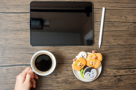 Happy Halloween day with Cookie, coffee and tablet. online shopping, Hello October, fall autumn, Festive, party and holiday conceptの写真素材