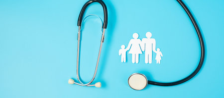 Happy Family day. Stethoscope and paper shape cutout with Father, Mother, and Children. international day of families, Health, wellness, Life and Insurance concepts.の写真素材