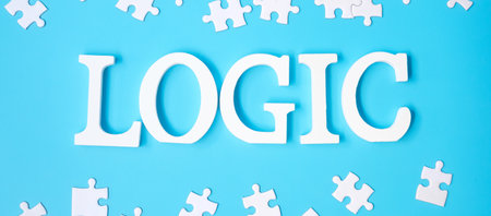 LOGIC text with white puzzle jigsaw pieces on blue background. Concepts of logical thinking, Conundrum, solutions, rational, strategy, world logic day and Educationの写真素材