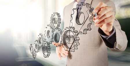businessman hand draws gear to success conceptの写真素材