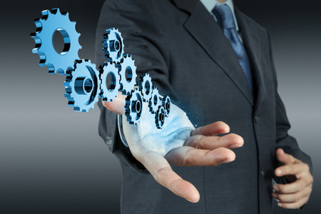 businessman hand show gear to success as conceptの写真素材