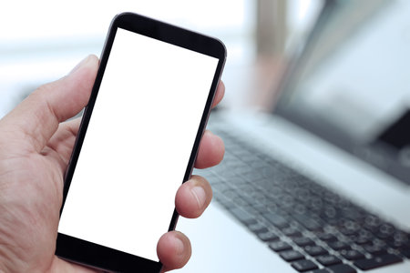 Closeup of Hand holding Blank Screen of Smat phone with blurred background as concept