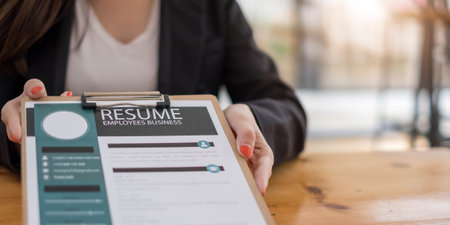 Businesswoman submits resume employer to review job application information on the desk, presents the ability for the company to agree with the position of the job.の写真素材