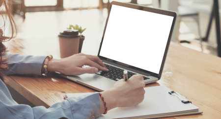 Cropped photo portrait of woman writing making list taking notes in notepad working on laptop...