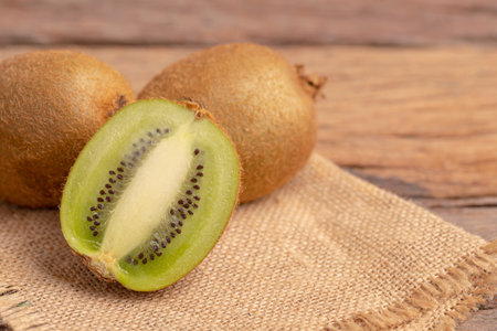A half of kiwis slice placed on the brown sack.の写真素材