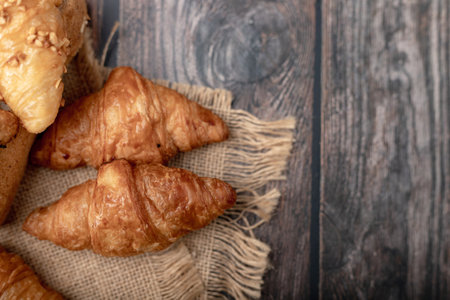 Croissants on the sack and wooden table
