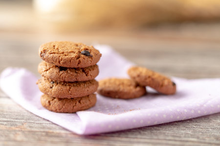 Cookies are stacked on handkerchiefs and wooden tables.