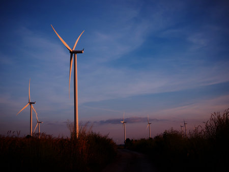 wind turbine in grass field with twilight