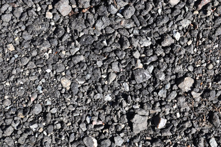 Detailed close up view on pebbles and stones on a gravel ground texture in high resolutionの写真素材