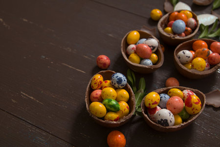 Easter hunt background with chocolate eggs on wooden backround copy space.の写真素材