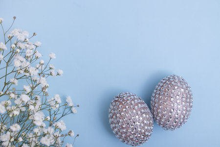 Glamorous Easter eggs with flowers. Cheerful table decorations for the spring holiday. Fashion minimal concept.の写真素材