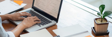 hands close up Freelancer busy working on a laptop computer on desktopの写真素材