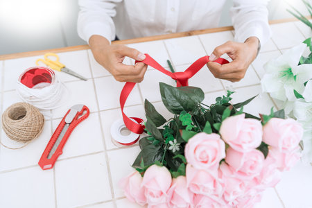 young women business owner florist making or Arranging Artificial flowers vest in her shop, craft and hand made concept.の写真素材