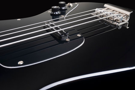 black bass guitar on black background.の写真素材
