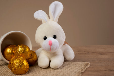 chocolate truffles wrapped in golden foil next to Easter ornaments.