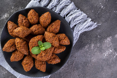 Traditional Arabian fried snack made with wheat and stuffed with minced meat. Quibe.