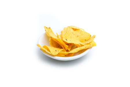 Tortilla chips in small white bowl isolated on white background