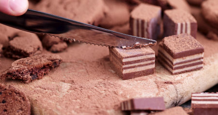 puff chocolate cream candy on a cutting board, cutting candy on a board with a knifeの写真素材