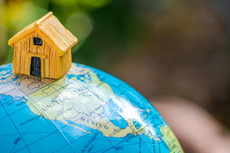 House or Home model with communication on globe model. Concept for loan, property ladder, financial,...
