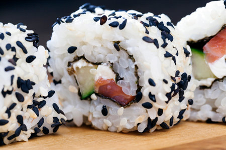 made from rice and trout or salmon with avocado sushi food, asian rice and seafood food on the table during meals, asian fish and avocado food itemsの写真素材
