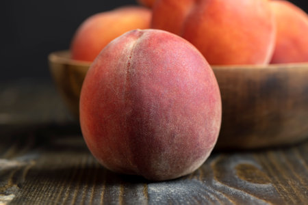 Ripe fresh peaches on a wooden table, a large number of washed and clean peachesの写真素材
