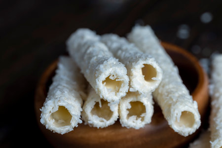 Waffle tubes with butter cream and coconut sprinkles, sweet waffle tubes with filling