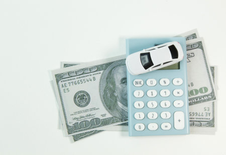 The white car toy and blue calculator white background.