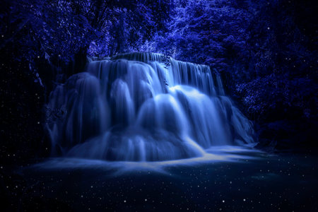 Beautiful waterfall nature scenery of colorful at a night deep tropical fantasy jungleの写真素材