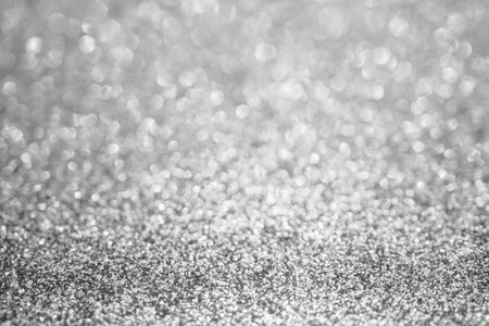 Abstract blur silver glitter sparkle defocused bokeh light backgroundの写真素材