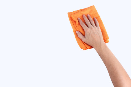 Hands holding cleaning rag microfiber cloth isolated on white backgroundの写真素材
