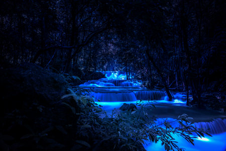 Beautiful waterfall nature scenery of colorful at a night deep tropical fantasy jungleの写真素材