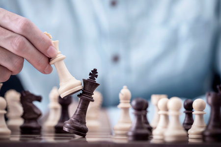 Businessman play with chess game in competition success play, concept strategy and successful management or leadershipの写真素材