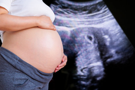 Pregnant Woman with ultrasound equipment background in hospital