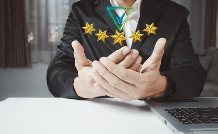 Hand shows the sign of the top service Quality assurance 5 star, Guarantee, Standards, ISO certification and standardization concept.の写真素材