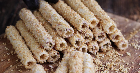 take delicious waffle tubes from the pile, take a waffle tube in peanuts while eating