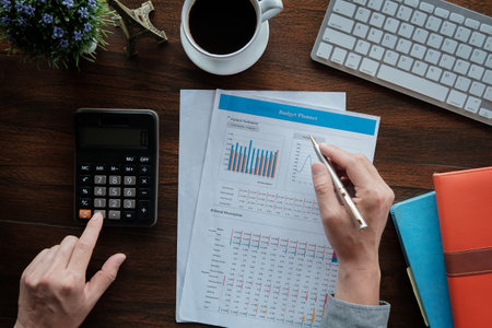 Business accounting concept, Business man using pen pointing  with data budget planner chart and...
