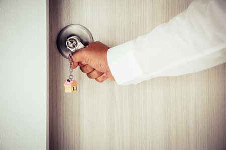 Open door with keys, Real estate agent showing new houseの写真素材