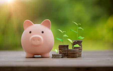 Money coin stack growing graph with piggy bank saving concept. business finance and saving money investment, plant growing up on coin. Balance savings and investment. save retirement for interest ideaの写真素材