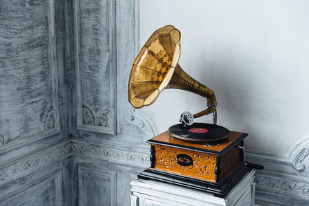 Music device. Old gramophone with plate or vinyl disk on wooden box. Antique brass record player. Gramophone with horn speaker. Retro entertainment concept.の写真素材