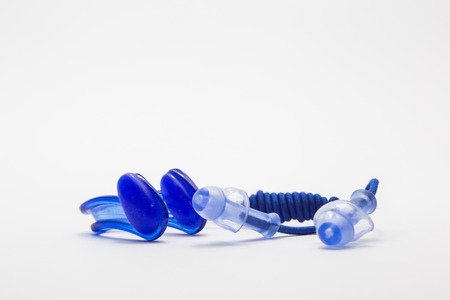 Nose clip and ear plugs for swimming pool on white background. Sport equipment, blueの写真素材