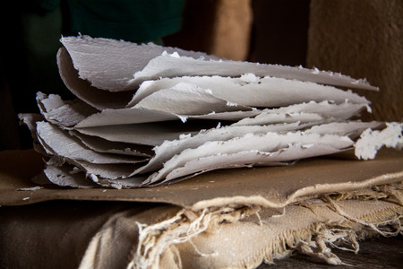 Stack of paper sheets in an ancient paper mill. Old traditional process of paper productionの写真素材