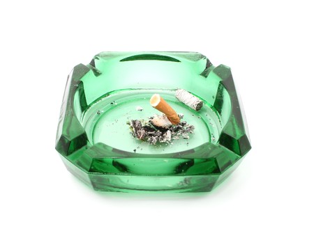 cigarette in green ashtray isolated on whiteの写真素材