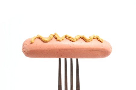 sausage on fork isolated on whiteの写真素材