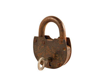 an old rusty key lock securely locking the doorの写真素材